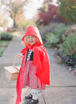 little girl wears little red riding hood costume for dress up