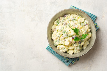Egg salad with red onion and greens in bowl on concrete background. Top view, copy space.