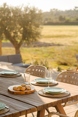 Dinner table setting in modern villa terrace