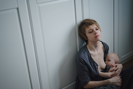 Young woman breastfeeding a child