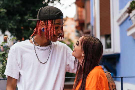 two friends enjoying the moment together, looking at each other on the street.
