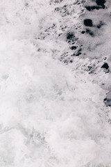 Obraz premium seething sea foam from a wave that broke on a rock. natural sea background