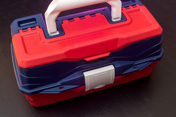 Plastic suitcase box with tool lock    isolated on dark background. industry