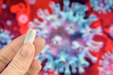 Pills in woman hand on blurred coronavirus bacteria’s on background. Coronavirus disease named COVID-19. Healthcare concept 