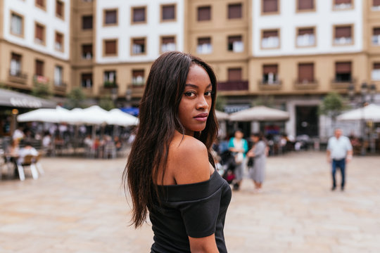 Portrait of a african woman with long hair looking at the camara
