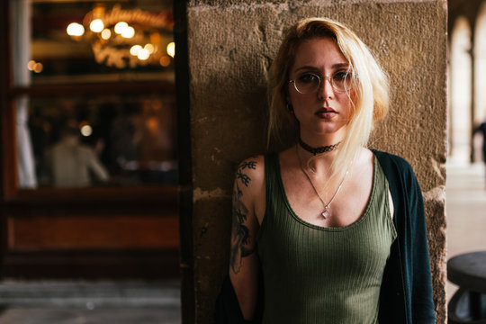 Close up Blonde hair woman with glasses, tattoos and make up.