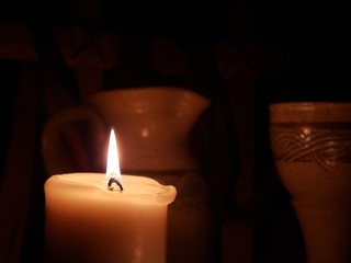 Candle on Left Side with Communion Cup and Pitcher in the backdrop