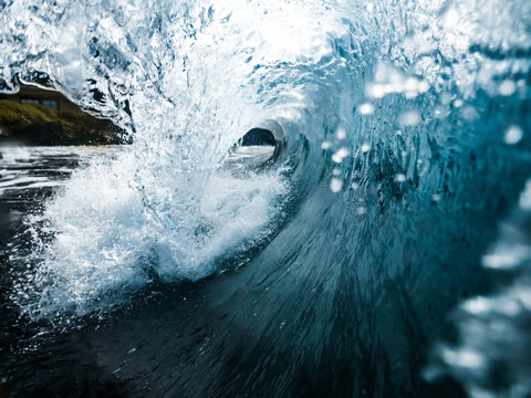 Big Clear Blue Ocean Wave Breaking Shot from Inside Barrel with Splash on Shore in Maui Hawaii
