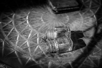 glass paint bottles on patterned surface in black and white