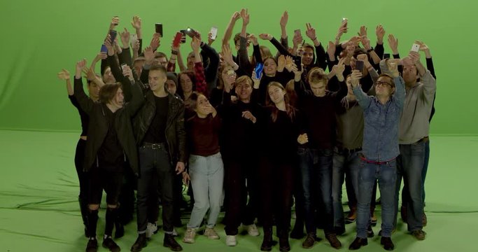 GREEN SCREEN CHROMA KEY Model released, Front view of huge crowd jumping and cheering at a concert or a show. Shot on RED Helium 8K in RAW