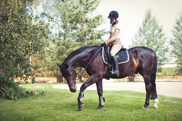 Fototapeta premium Young pretty girl riding horseback