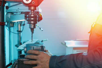 Worker installs a metal part