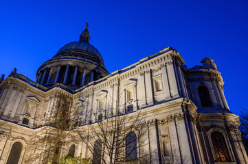 St. Paul's Cathedral in London, UK. Evening view of St Paul's taken from the southeast of the cathedral. Illuminated building and clear dark blue sky