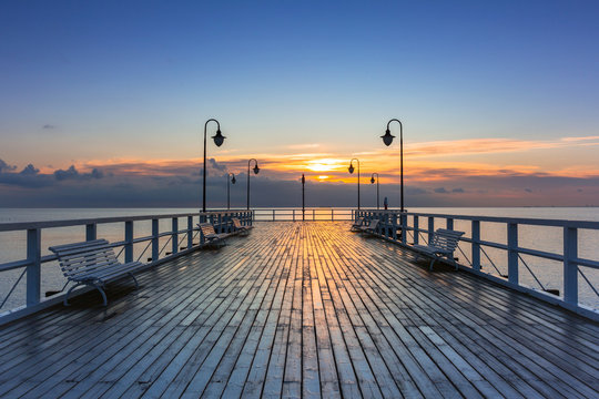 Fototapeta Beautiful landscape with wooden pier in Gdynia Orlowo at sunrise, Poland