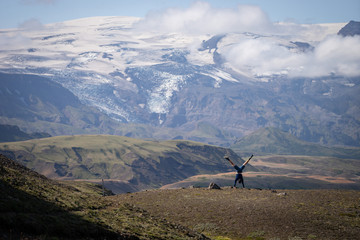 Caucasian young guy jumping in over mountain and canyon background on the way of Laugavegur trail, Iceland. Promoting healthy lifestyle - obrazy, fototapety, plakaty