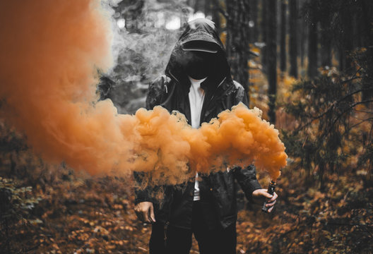 People Holding Colored Smoke Bombs on a Shore · Free Stock Photo