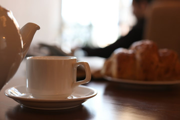 Delicious morning coffee and croissant served for breakfast on wooden table