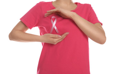 Woman with pink ribbon on white background, closeup. Breast cancer awareness