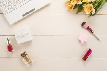 Office table with flowers and women's things	