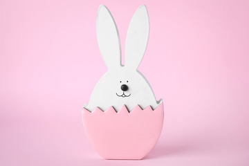 Bunny figure as Easter decor on pink background