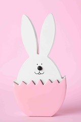 Fototapeta premium Bunny figure as Easter decor on pink background