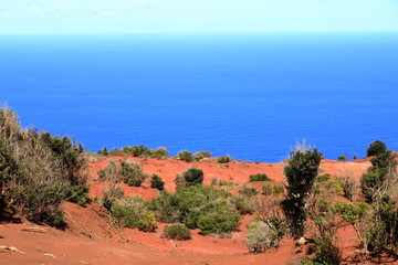 Colorful red earth and sand hills of volcanic origin above 
