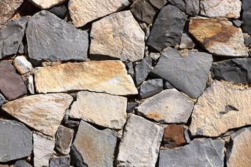 Texture of a yellow granite stone wall for background