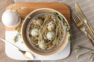 Rustic Easter table setting with eggs and floral decor, flat lay