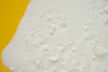 Baking soda (Sodium bicarbonate) .Baking soda on a bright yellow background. Ingredient for baking.  Bio Cleanser.top view, copy space.