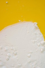 Baking soda (Sodium bicarbonate) .Baking soda on a bright yellow background. Ingredient for baking.  cleanliness. Bio Cleanser.top view, copy space.