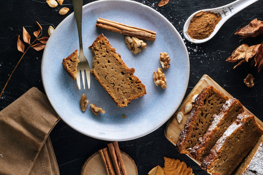 A slice of pumpkin sponge cake on a blue plate