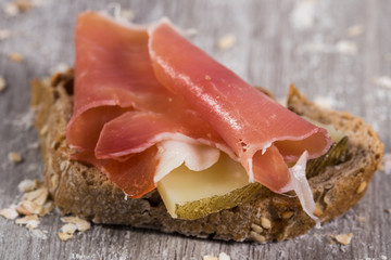 sandwich made with rye bread cheese and Parma ham