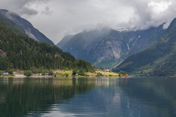 Fototapeta na wymiar End of fjord. Beautiful Norwegian landscape. view of the fjords. Norway ideal fjord reflection in clear water In cloudy weather. selective focus