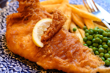 Traditional British food fish and chips served with green peas