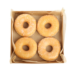 Delicious donuts in box isolated on white, top view