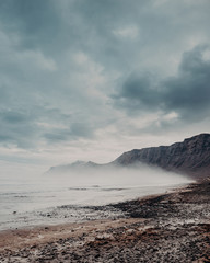 the morning fog on the beach of famara on the island Lanzarote