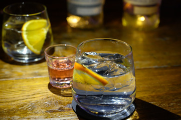 Glass of gin with tonic water, orange and ice