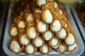 Sweet italian desssert, pile of cannoli pastry filled with ricotta cream cheese