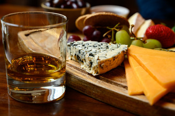 Tasting of original scottish cheese and whisky, plate with scottish cheeses and variety of Scotch...