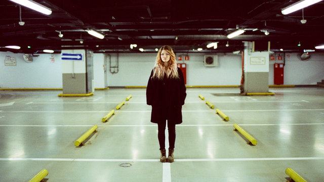 Portrait of a woman who stands in an underground parking lot