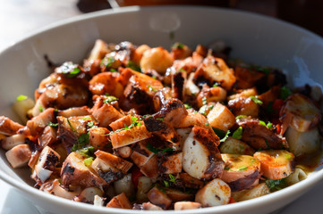 Tastes of Spain, fresh homemade Galician octopus salad with red paprika and parsley