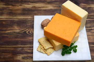 Leicestershire cheese or red leicester and mature cheddar, variety of British hard cheeses made from cow milk