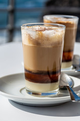 Special coffee of Canary islands, sweet barraquito coffee with layers and alcohol served in glass