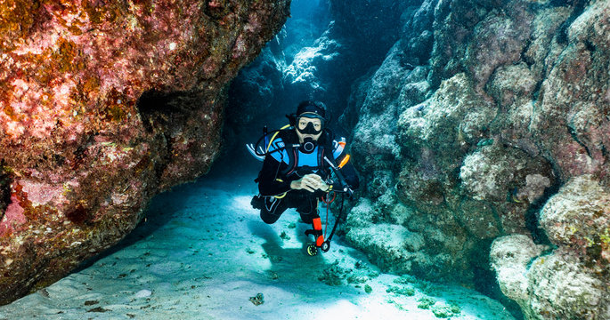 scuba diver exploring a canyon at the great barrier reef in Australia