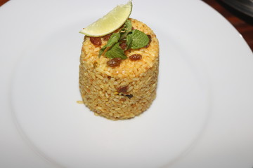 yellow,biryani cup rice plate with lemon slice,plams