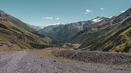 Landscape view of an unpaved road and valley, Terskol, Mount Elbrus, Caucasus, Russia.