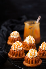 Homemade carrot cupcakes with caramel sauce and cream cheese frosting