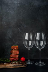 four types of frying meat, rare, medium, medium well, well  done  on a fork and two glasses of wine...