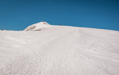 Landscape view of Mount Elbrus eastern peak (5642m) in Caucasus, Russia.  Path leading group of...