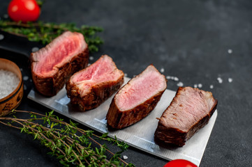 Four steaks on knife on a stone background. Four types of meat frying Rare, Medium, Medium Good, Well done